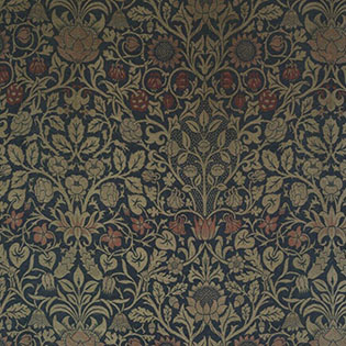 A detail of a woven upholstery textile of muted, earthy tones of green, blue, and burgundy, woven into intricate floral patterns of abstracted violets and columbine flowers.